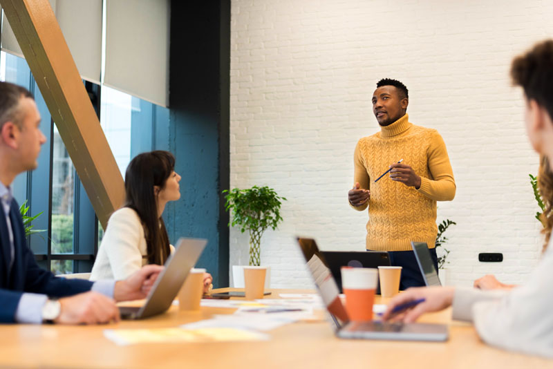 black male team leader at business meeting in an office